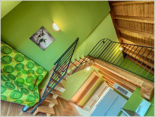 a staircase in a room with a green ceiling at Fantastica Casa Poppo in Bellano