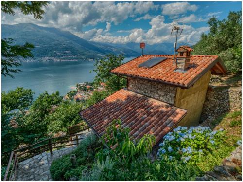 a house on a hill with a view of a lake at Fantastica Casa Poppo in Bellano