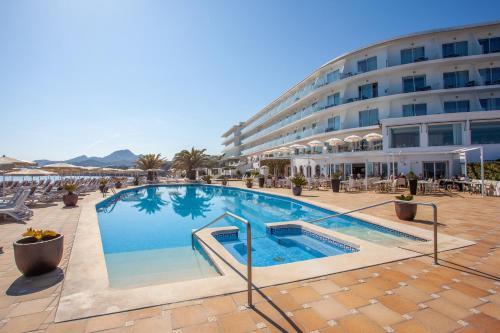 a large swimming pool in front of a hotel at Grupotel Aguait Resort & Spa - Adults Only in Cala Ratjada