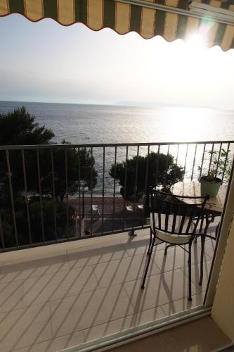 a balcony with a table and a view of the ocean at Vila Snježana Tučepi in Tučepi