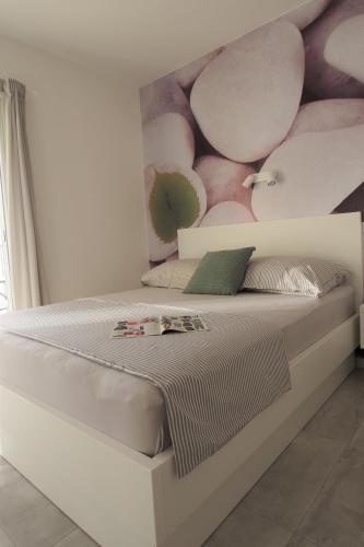a bedroom with a bed with a flower mural on the wall at Vila Snježana Tučepi in Tučepi