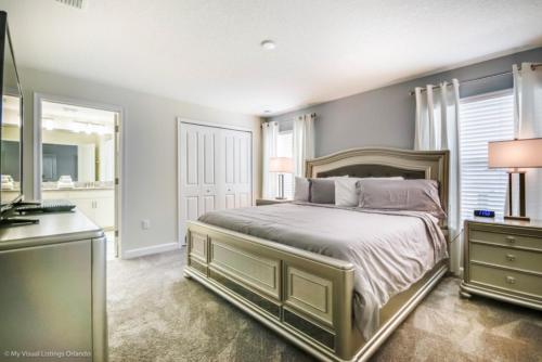 a bedroom with a large bed and a bathroom at Imagine You and Your Family Renting this 5 Star Home on Champions Gate Resort, Orlando Townhome 2539 in Davenport
