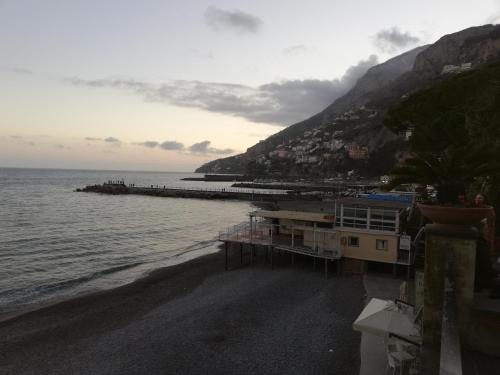 a view of a beach with a building and the ocean at IL PARADISO DEGLI DEI 2 in Agerola