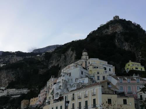 a building on a hill with a mountain in the background at IL PARADISO DEGLI DEI 2 in Agerola