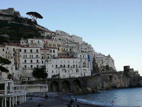a group of buildings on a hill next to the water at IL PARADISO DEGLI DEI 2 in Agerola