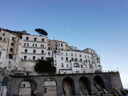 a building with a tree on top of a bridge at IL PARADISO DEGLI DEI 2 in Agerola