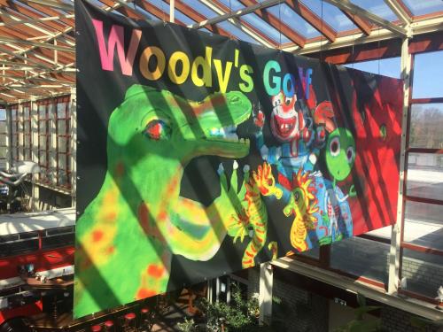 a banner for woodys go sign in a store at Hotel Den Helder in Den Helder