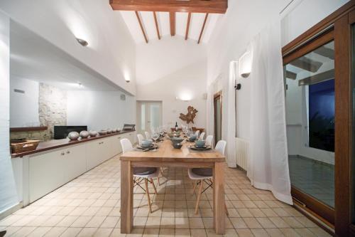 a kitchen and dining room with a wooden table and chairs at Luxury Villa with panoramic views over Moraira in Teulada