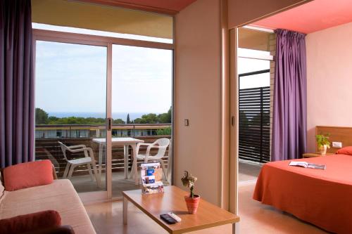 um quarto de hotel com vista para uma varanda em Aparthotel Comtat Sant Jordi em Platja  d'Aro