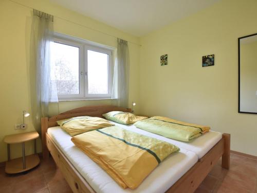 two twin beds in a room with a window at Peaceful Apartment in Zierow with Terrace in Zierow