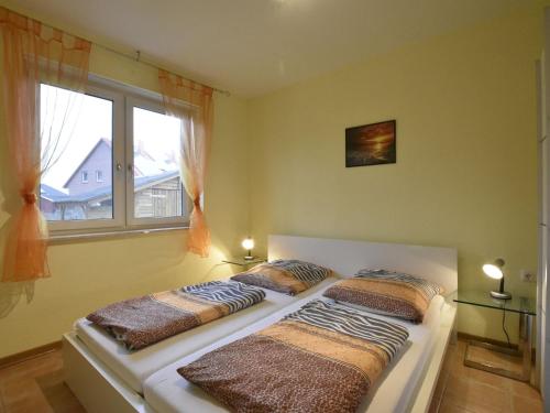 two beds in a room with a window at Idyllic Holiday Home in Zierow with Roofed Terrace in Zierow