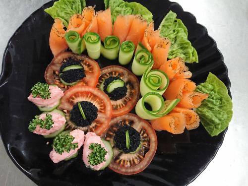 a plate of food with sushi and vegetables on it at Hotel & Ferienwohnungen Bohlenblick in Saalfeld
