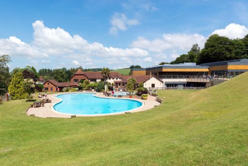 an overhead view of a swimming pool in a green field at Cofton Holidays in Dawlish
