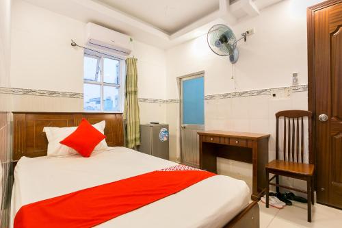 a bedroom with a bed and a desk and a window at Song Xanh Hotel near SECC - FV in Ho Chi Minh City