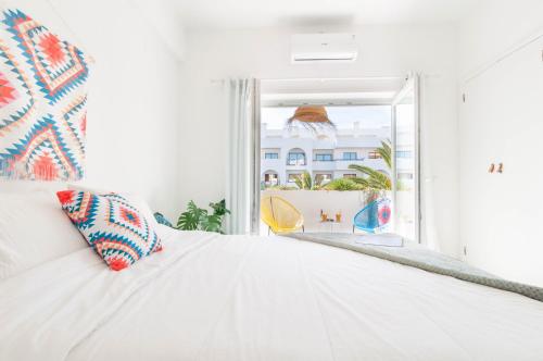 a white couch in a room with a window at Algarve Beaches Apartment by Portugal Collection in Porches