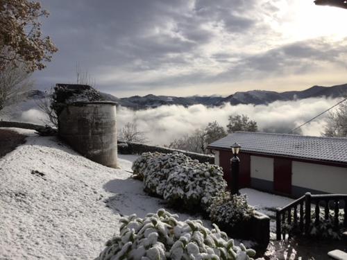 a house in the snow with a view of the mountains at Casa Katton in Etxalar