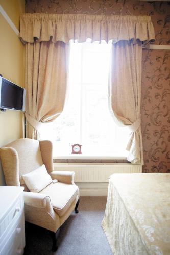Ένα ή περισσότερα κρεβάτια σε δωμάτιο στο Cotford Hotel