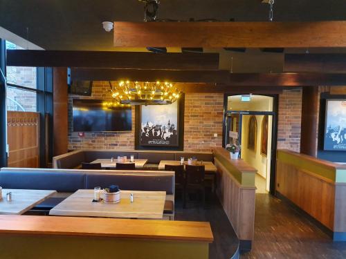 a restaurant with tables and chairs and a brick wall at Hotel Hafenresidenz Stralsund in Stralsund