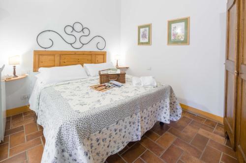 a bedroom with a bed with a table with a white spread at Ancora del Chianti in Greve in Chianti