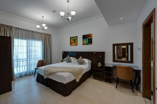 a bedroom with a bed and a desk and a mirror at J5 Four Bedroom Villa Holiday home in Mirdif in Dubai