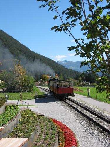 a small train traveling down the tracks at Hotel Klingler in Maurach