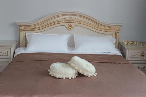 a bed with two pillows on top of it at Апарт отель Welcome in Taldykorgan