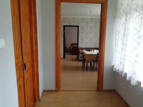 an open door to a dining room with a table at Racha guest house MERO in Ambrolauri