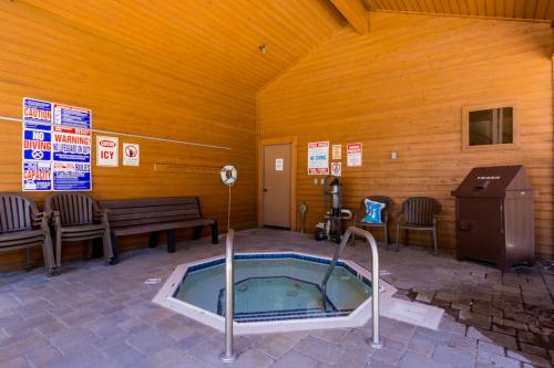 a jacuzzi tub in a room with a wooden wall at Mountainback 80 in Mammoth Lakes