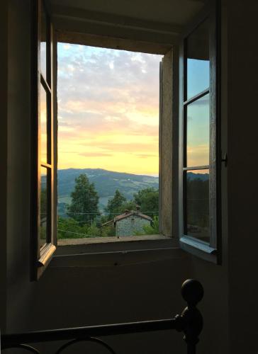 an open window with a view of the mountains at B&B Antico Mulino in Camugnano
