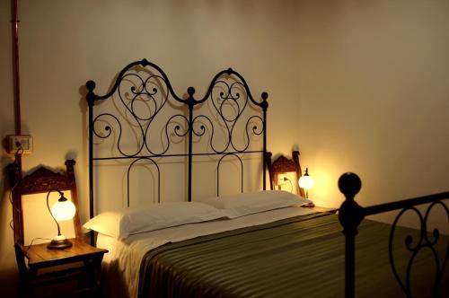 a bedroom with a large bed and two lamps at B&B Antico Mulino in Camugnano