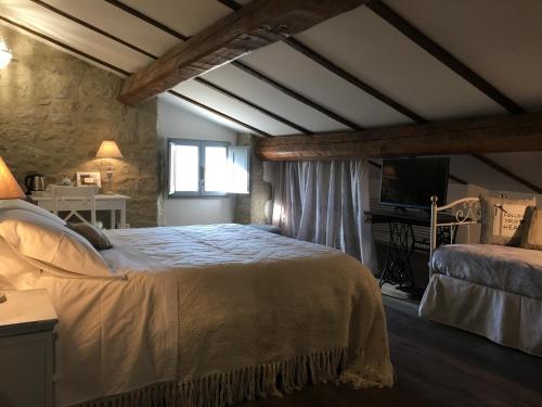 a bedroom with a large bed in a room at B&B Antico Mulino in Camugnano