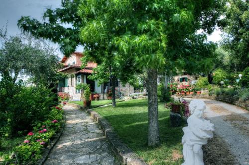 a statue in front of a yard with a house at B&B Villa Miramì in Saturnia