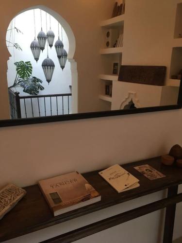a counter in a room with a mirror and a window at Dar 23 in Tangier
