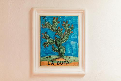 a framed painting of a cactus on a wall at Sanbernabé tres in Guanajuato