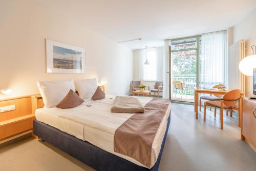 um quarto com uma cama grande e uma sala de jantar em Rügener Ferienhäuser am Hochufer em Göhren