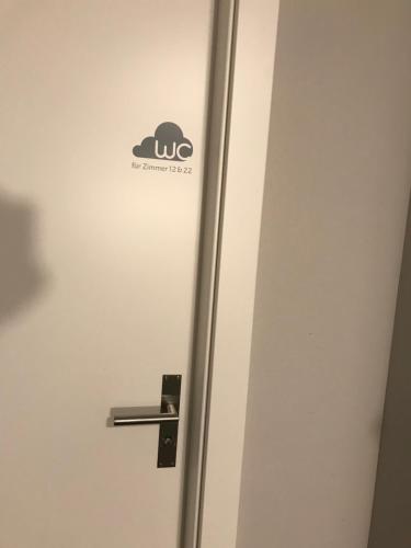 a door with a sign on it in a room at wolke 4 in Büren an der Aare