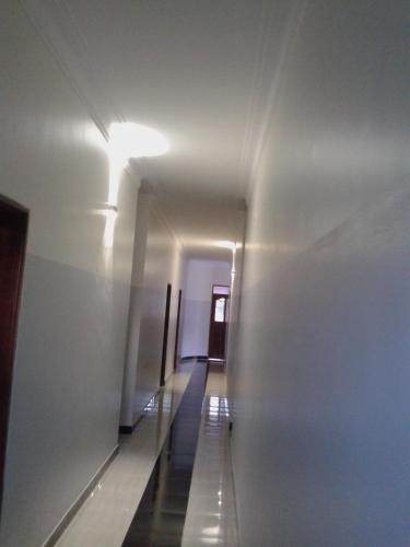 a long hallway with a light on the wall at FREEDOM Guest House in Wakiso