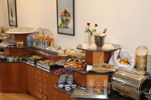 a buffet line with a lot of food on display at Hotel Römerhof Hanau by Trip Inn in Hanau am Main