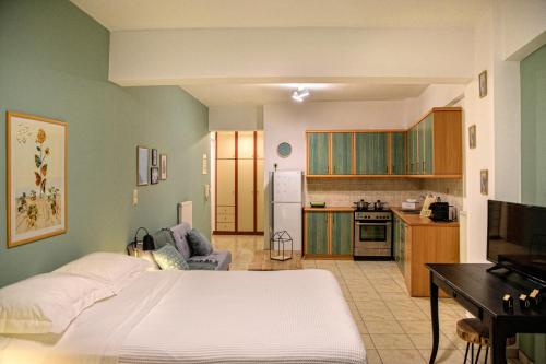 1 dormitorio con 1 cama blanca y cocina en Casa Industriale, en Kalamata