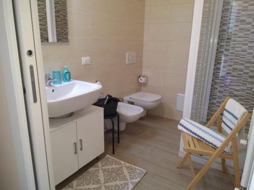 a bathroom with a sink and a toilet at Danilo Apartments in Baveno