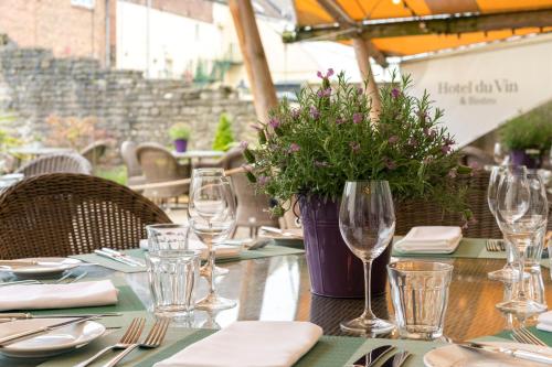 a table with wine glasses and a vase of flowers at Hotel Du Vin Poole in Poole