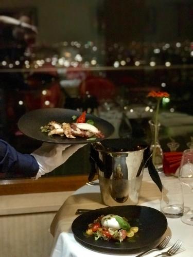a person holding a plate of food on a table at Atlantic Hotel - Free Parking in Sofia