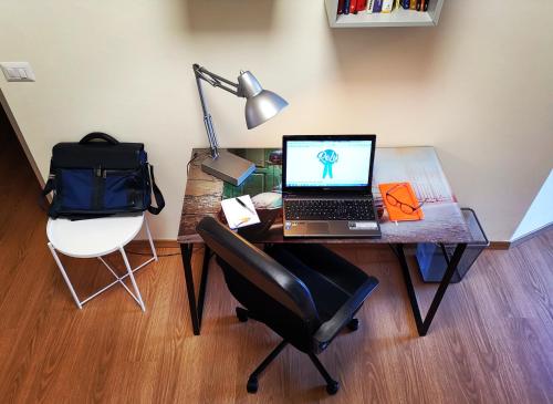 a desk with a laptop and a chair on it at ReLù, l'appartamento vicino allo Juventus Stadium in Turin