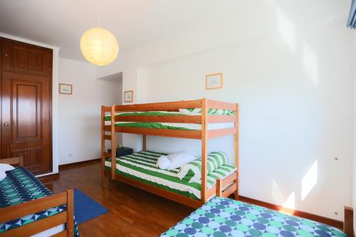 a bedroom with two bunk beds in a room at Sotto Mayor Residence in Figueira da Foz