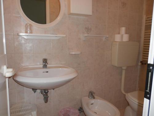 a bathroom with a sink and a toilet at Hotel Laguna Blu in Rimini