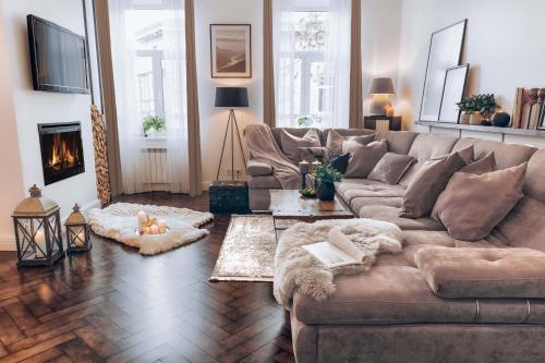 a living room with a couch and a fireplace at Scandinavian style of Lux Apartments in Lviv in Lviv