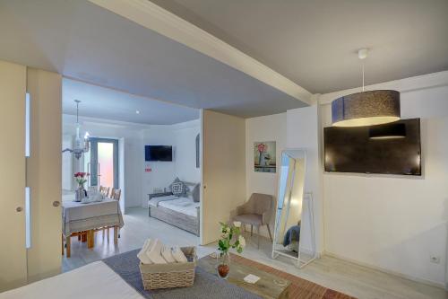 a living room and dining room with a couch and a table at Inn Bairro Alto BA Sweet in Lisbon