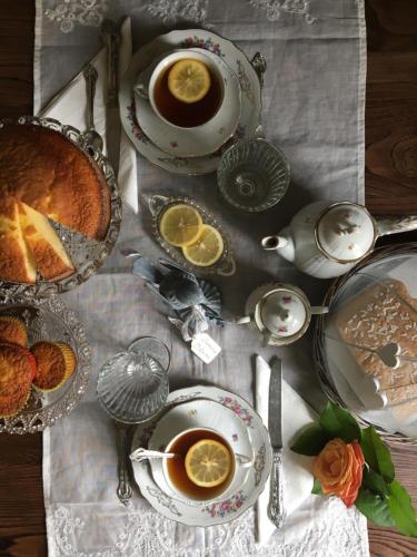 a table with cups of coffee and a cake on it at B&B Antico Mulino in Camugnano