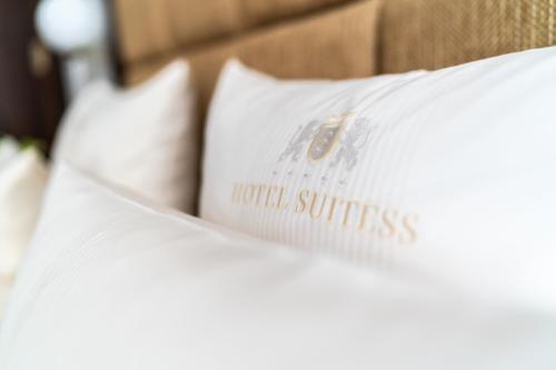 a group of white pillows on a bed at Hotel Suitess in Dresden