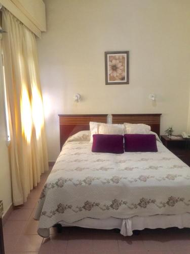 a bedroom with a large bed with two pillows at Hotel Plaza San Juan in San Juan